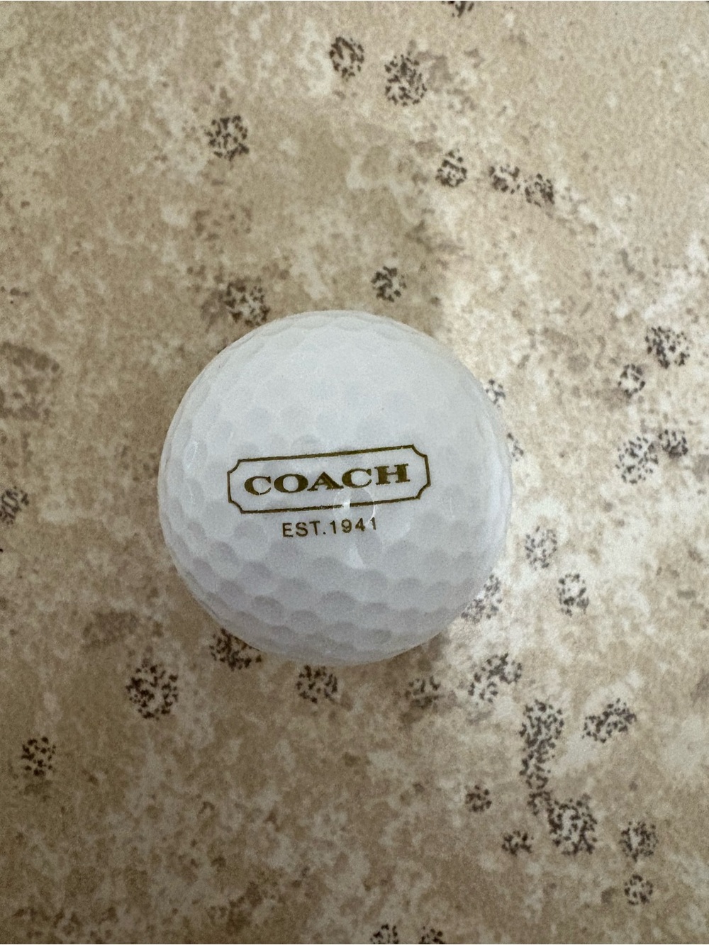 Coach designer golf ball features the brand's logo and "EST. 1941" text